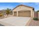 Lovely home showcasing a three-car garage with decorative doors and a concrete driveway at 2634 N 164Th Ave, Goodyear, AZ 85395