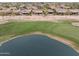 Stunning aerial view of a golf course community with a lake and lush greenery at 2634 N 164Th Ave, Goodyear, AZ 85395