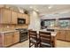 Well-lit kitchen with stainless steel appliances, granite countertops, and light wood cabinetry at 2634 N 164Th Ave, Goodyear, AZ 85395