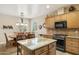 Bright kitchen with granite countertops, stainless appliances, and an adjacent dining area at 2634 N 164Th Ave, Goodyear, AZ 85395