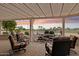 Inviting covered patio featuring a charming rock waterfall and comfortable seating with serene golf course views at 2634 N 164Th Ave, Goodyear, AZ 85395