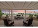 Enjoy sunset views on this covered patio with a rock waterfall feature and desert landscaping at 2634 N 164Th Ave, Goodyear, AZ 85395