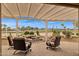 Covered patio with seating area and water feature, providing picturesque views of the golf course at 2634 N 164Th Ave, Goodyear, AZ 85395