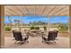 Covered patio features comfortable seating and a beautiful water feature overlooking the golf course at 2634 N 164Th Ave, Goodyear, AZ 85395