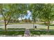 Community basketball court surrounded by lush greenery and mature trees at 2746 S Harmony Ave, Gilbert, AZ 85295