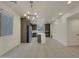 Open kitchen and dining area featuring modern light fixture, stainless appliances, and tile flooring at 2746 S Harmony Ave, Gilbert, AZ 85295