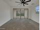 Bright living room with sliding glass door to the balcony; neutral color pallette at 2746 S Harmony Ave, Gilbert, AZ 85295