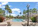 Resort-style pool area with palm trees, lounge chairs, and a pool house at 2746 S Harmony Ave, Gilbert, AZ 85295