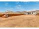 Expansive backyard with modern home, privacy fence, and natural desert surroundings at 2940 E South Mountain Ave, Phoenix, AZ 85042