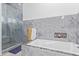 Bathroom showing an elegant soaking tub with marble accents and a glass enclosed shower at 2940 E South Mountain Ave, Phoenix, AZ 85042