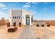 Modern, two-tone home with desert landscaping, visible with a paved walkway leading to the front door at 2940 E South Mountain Ave, Phoenix, AZ 85042