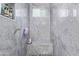 Bathroom showing a shower with marble accents, a window and a built-in bench at 2940 E South Mountain Ave, Phoenix, AZ 85042