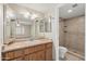 Bright bathroom featuring a vanity with double mirrors and a walk-in shower at 3129 W Mohawk Ln, Phoenix, AZ 85027