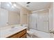 Well-lit bathroom with a vanity sink, large mirror and a shower over tub with glass doors at 3129 W Mohawk Ln, Phoenix, AZ 85027