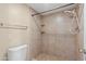 Neutral bathroom featuring tiled shower and toilet at 3129 W Mohawk Ln, Phoenix, AZ 85027