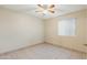 Neutral bedroom with ceiling fan, tile floors and a window at 3129 W Mohawk Ln, Phoenix, AZ 85027