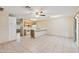 Open-concept living room and kitchen with tile floors and a ceiling fan at 3129 W Mohawk Ln, Phoenix, AZ 85027