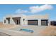 Contemporary home featuring a stone accent wall, black trim and a two car garage at 33949 N Borgata Trl, San Tan Valley, AZ 85144