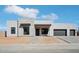 Contemporary home featuring a stone accent wall, black trim and a two car garage at 33949 N Borgata Trl, San Tan Valley, AZ 85144