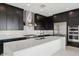 Stylish kitchen featuring quartz countertops, stainless appliances, and a professional-grade range at 33949 N Borgata Trl, San Tan Valley, AZ 85144