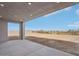 Covered patio with concrete flooring offering a view of the sandy backyard at 33949 N Borgata Trl, San Tan Valley, AZ 85144