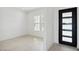 Modern room with tile flooring and contemporary black door at 33949 N Borgata Trl, San Tan Valley, AZ 85144