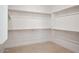 Walk-in closet with ample storage shelving and custom wood rods at 33949 N Borgata Trl, San Tan Valley, AZ 85144