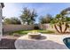 An entertainer's backyard with a built-in fire pit, putting green, and desert landscaping at 4102 E Crescent Way, Chandler, AZ 85249