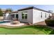 Backyard view featuring a putting green, custom fire pit, desert landscaping and view of the pool at 4102 E Crescent Way, Chandler, AZ 85249