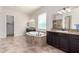 Relaxing bathroom with a soaking tub, granite countertops, dark cabinets and ample lighting at 4102 E Crescent Way, Chandler, AZ 85249