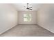 Large carpeted bedroom with neutral walls, a ceiling fan, and a window offering ample natural light at 4102 E Crescent Way, Chandler, AZ 85249