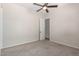 Neutral bedroom with carpet, light walls, a ceiling fan, and a white door leading to another room at 4102 E Crescent Way, Chandler, AZ 85249