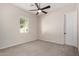 Neutral bedroom offers carpet, a ceiling fan, a window providing natural light, and white trim at 4102 E Crescent Way, Chandler, AZ 85249