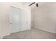 Bedroom with neutral carpet, double sliding closet doors, and light-colored walls at 4102 E Crescent Way, Chandler, AZ 85249