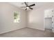 Bright bedroom featuring neutral carpet, ceiling fan, and a window offering natural light at 4102 E Crescent Way, Chandler, AZ 85249