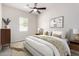 Bright bedroom with neutral decor, ceiling fan, and a decorative accent wall at 4102 E Crescent Way, Chandler, AZ 85249