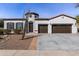 Charming home with a turret entry, brown shutters, two-car garage, and desert landscaping at 4102 E Crescent Way, Chandler, AZ 85249