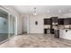 Modern kitchen with dark cabinetry, granite countertops, and an adjacent dining area at 4102 E Crescent Way, Chandler, AZ 85249