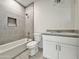 Modern bathroom featuring a bathtub, toilet, and a single vanity with gray countertop at 4240 N Arizona Rd, Eloy, AZ 85131