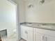 Well-lit bathroom featuring a double vanity with gray countertops and modern fixtures at 4240 N Arizona Rd, Eloy, AZ 85131