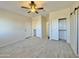 Bright bedroom with a ceiling fan, tile floors, and ample closet space for storage at 4240 N Arizona Rd, Eloy, AZ 85131