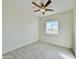 Bright bedroom with wood-look tile floors, a ceiling fan, and a window at 4240 N Arizona Rd, Eloy, AZ 85131