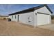 Exterior view of the home with white garage door and white stucco at 4240 N Arizona Rd, Eloy, AZ 85131