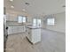 Open-concept kitchen with stainless steel appliances, white cabinetry, and a kitchen island at 4240 N Arizona Rd, Eloy, AZ 85131