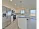 Bright, modern kitchen with stainless steel appliances, white cabinets, and a center island at 4240 N Arizona Rd, Eloy, AZ 85131