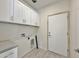 Laundry room with white cabinets, gray quartz countertop, and tile floor at 4240 N Arizona Rd, Eloy, AZ 85131