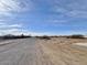 Wide shot of a long, empty street with sparse desert shrubbery at 4240 N Arizona Rd, Eloy, AZ 85131