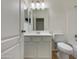 Clean bathroom featuring white cabinets, white walls, modern fixtures, and hard surface floors at 42618 W Oakland Dr, Maricopa, AZ 85138