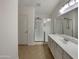 Well-lit bathroom featuring a walk-in shower and sleek vanity at 42618 W Oakland Dr, Maricopa, AZ 85138