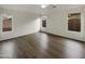 Bright, empty bedroom with neutral walls, ceiling fan, hard surface floors, and natural light from the windows at 42618 W Oakland Dr, Maricopa, AZ 85138